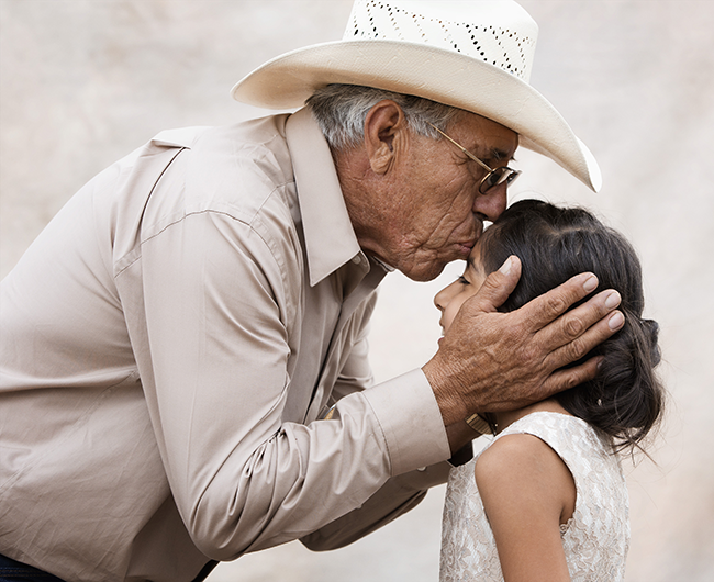 grandfather kissing granddaughter