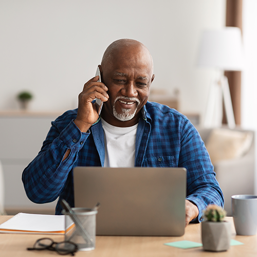 man on phone and computer