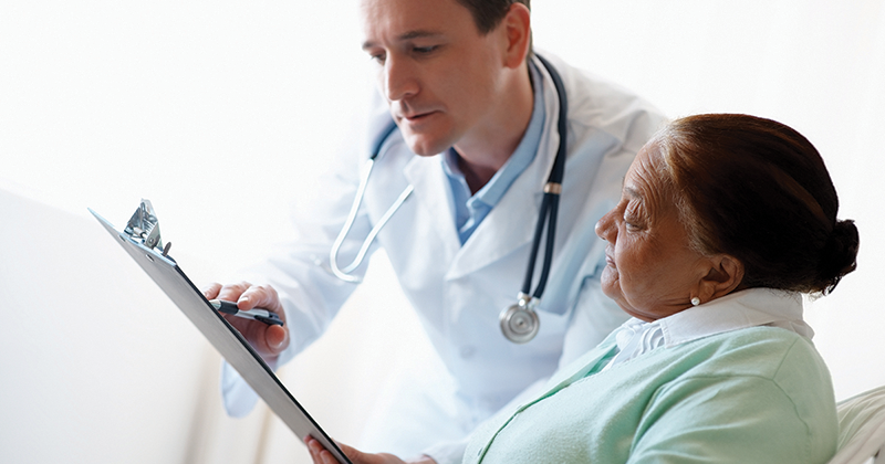 doctor reading information to patient 