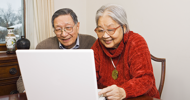 Elderly man and woman using a laptop