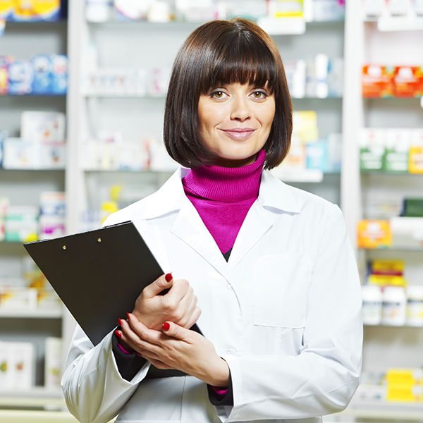 Pharmacist smiling holding clipboard